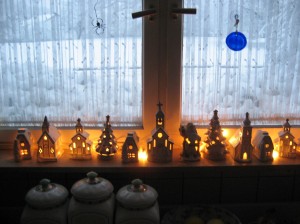 My little weisskirche (white church) collection glows warmly on the kitchen window sill with the wintry scene outside.